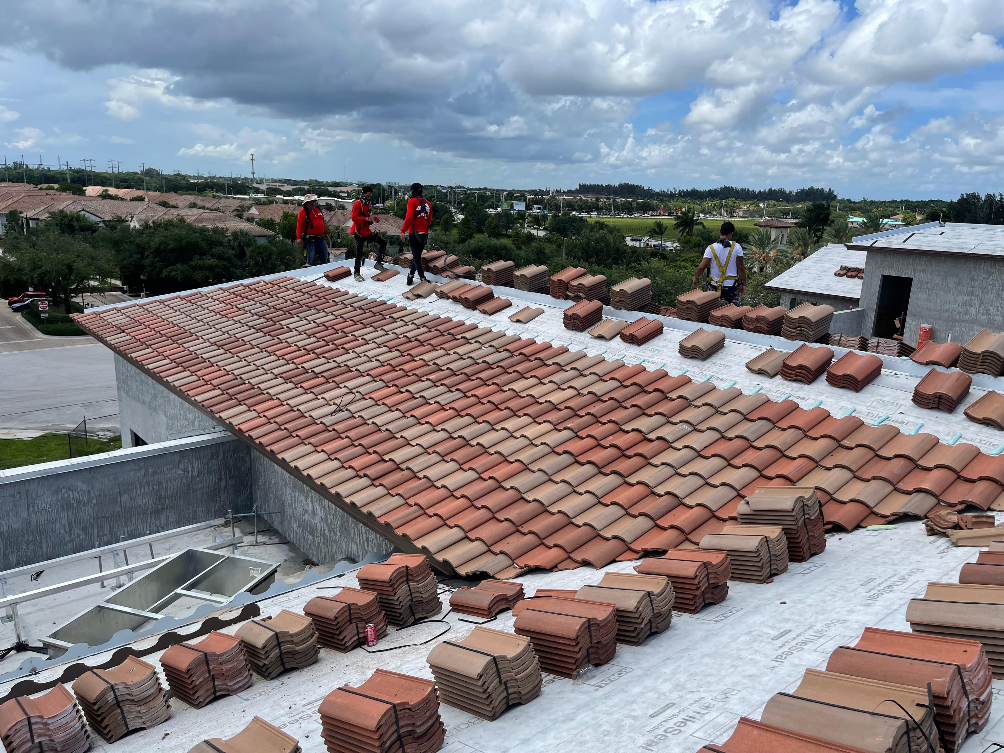 Extreme Roofing crew installing tile roof in South Florida